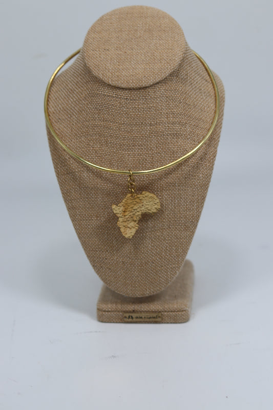 Handmade Kenyan brass choker necklace featuring a smooth rigid collar and a textured pendant in the shape of the African continent, displayed on a burlap jewelry bust.