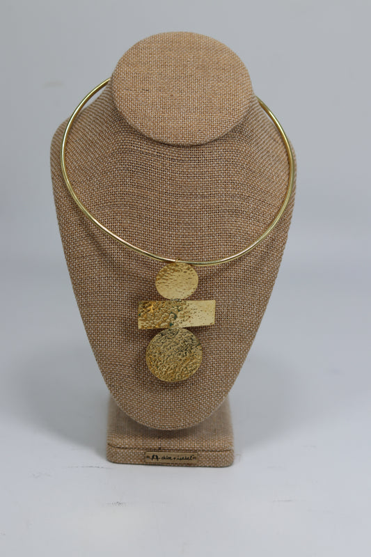 Elevate your look with this handmade Kenyan brass choker featuring a striking abstract pendant made of hammered circles and a bar. Ethical African artisan fashion designed to stand out. Shop yours today!